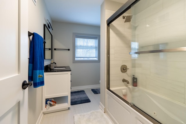 full bathroom with toilet, enclosed tub / shower combo, baseboards, tile patterned flooring, and vanity