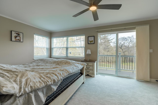 carpeted bedroom featuring crown molding, access to exterior, and ceiling fan