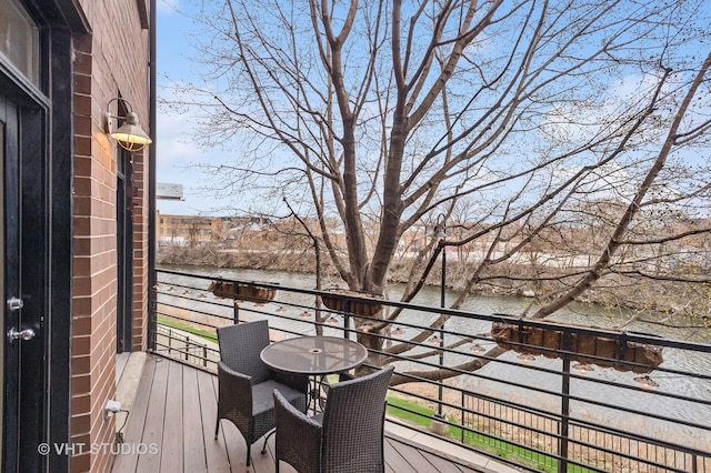 wooden deck featuring a water view
