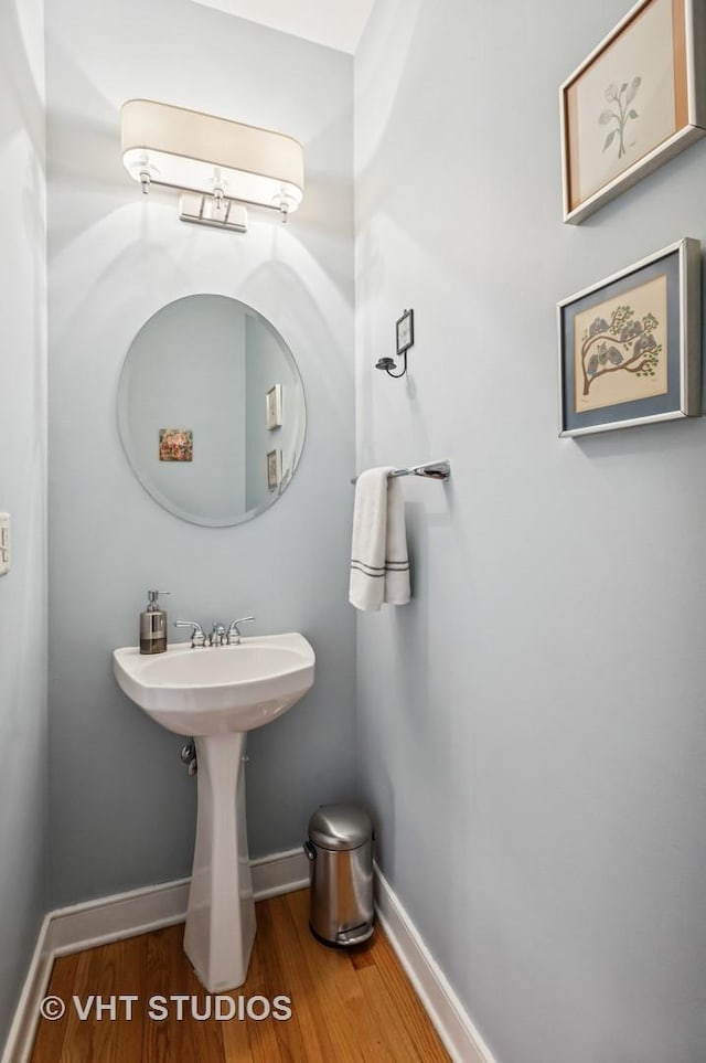bathroom with baseboards and wood finished floors