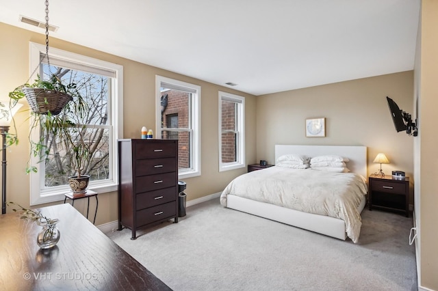bedroom featuring baseboards, visible vents, and carpet