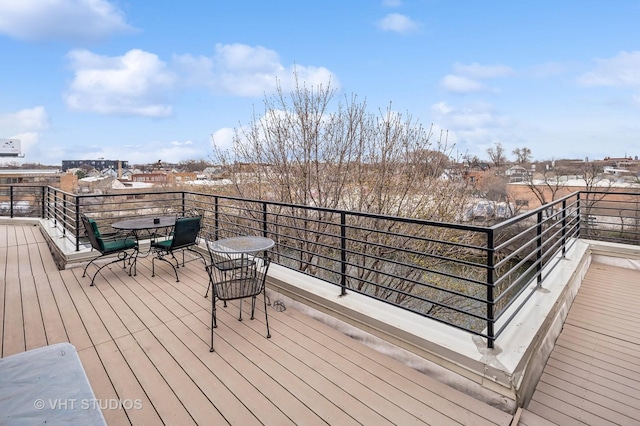 wooden terrace with outdoor dining area