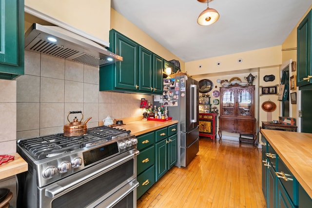 3800 N Lake Shore Dr Unit 5E, Chicago, IL 60613 - kitchen featuring wooden counters, high quality appliances, ventilation hood, green cabinets, and tasteful backsplash