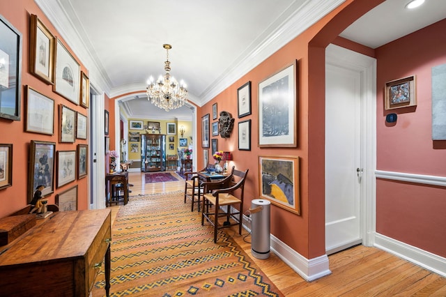 3800 N Lake Shore Dr Unit 5E, Chicago, IL 60613 - hall with an inviting chandelier, crown molding, baseboards, arched walkways, and light wood-style floors