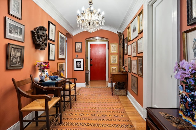 3800 N Lake Shore Dr Unit 5E, Chicago, IL 60613 - foyer featuring baseboards, light wood finished floors, crown molding, arched walkways, and a notable chandelier