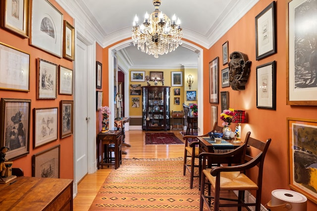 3800 N Lake Shore Dr Unit 5E, Chicago, IL 60613 - hallway with light wood finished floors, an inviting chandelier, ornamental molding, and arched walkways