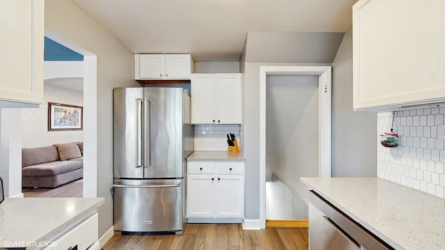 1421 Main St Unit 1421, Evanston, IL 60202 - kitchen featuring high quality fridge, light wood-style flooring, white cabinets, and tasteful backsplash