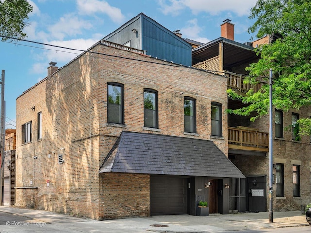 view of building exterior with concrete driveway and an attached garage