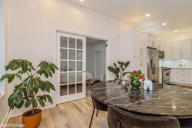 dining area with recessed lighting and light wood-style floors