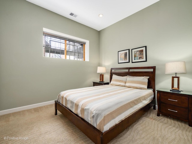 bedroom with light carpet, baseboards, and visible vents