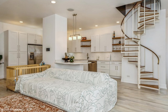 living area with recessed lighting, light wood-type flooring, and stairs