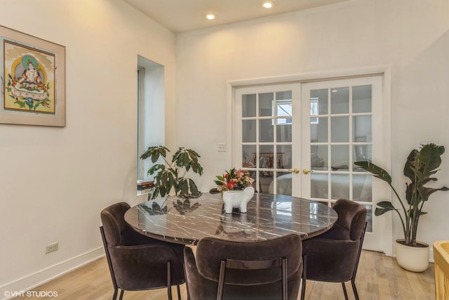 dining space with baseboards, recessed lighting, french doors, and light wood-type flooring