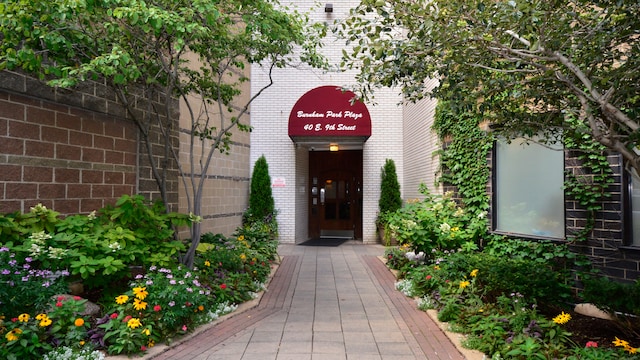 doorway to property featuring brick siding
