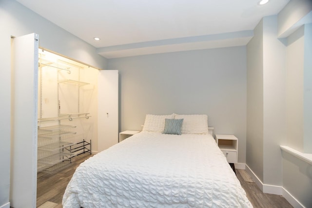 bedroom featuring dark wood-type flooring, baseboards, and recessed lighting