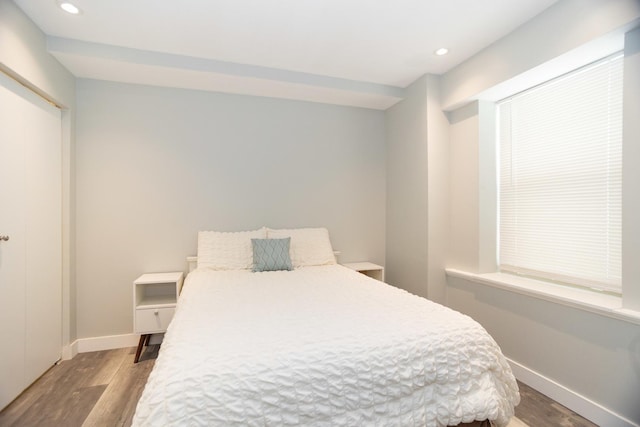 bedroom with baseboards, recessed lighting, and wood finished floors