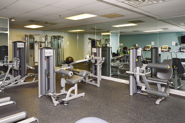 gym with a drop ceiling and visible vents
