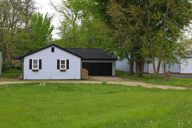 exterior space with an attached garage, driveway, and a front yard