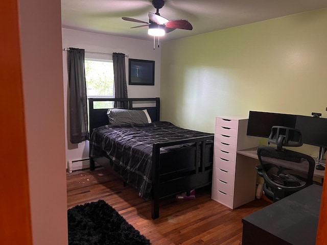 bedroom with hardwood / wood-style floors, a ceiling fan, and a baseboard heating unit