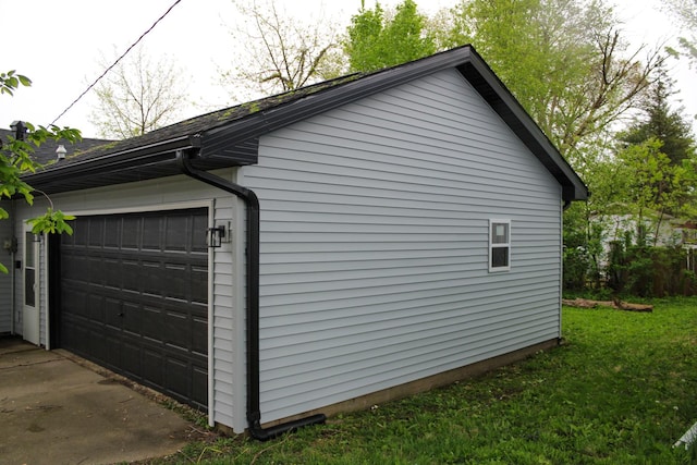view of home's exterior featuring a yard and a detached garage
