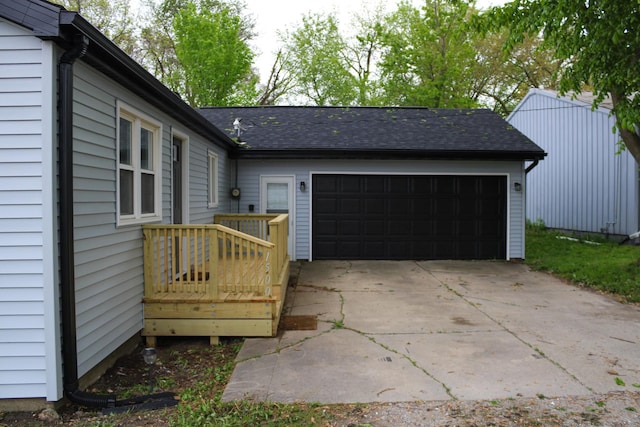 1500 E Jefferson St, Clinton, IL 61727 - view of side of home featuring an attached garage, driveway, and roof with shingles