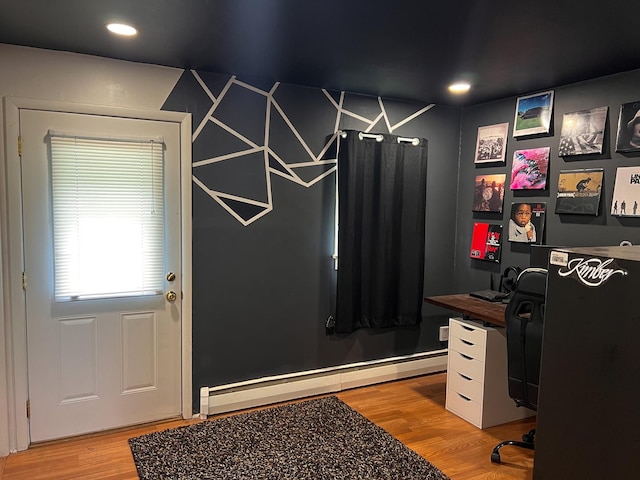 home office with a baseboard heating unit, recessed lighting, and light wood-type flooring
