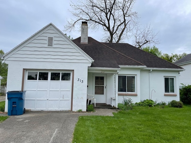 view of front of house with a chimney, stucco siding, a front yard, asphalt driveway, and an attached garage