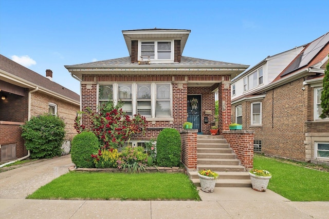 1306 Highland Ave, Berwyn, IL 60402 - view of front facade featuring brick siding, a front yard, roof with shingles, and covered porch