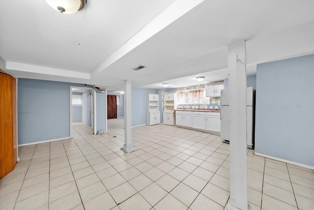 1306 Highland Ave, Berwyn, IL 60402 - below grade area featuring light tile patterned flooring and freestanding refrigerator