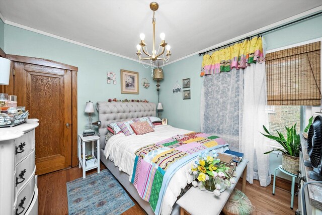 1306 Highland Ave, Berwyn, IL 60402 - bedroom featuring crown molding, wood finished floors, and a chandelier