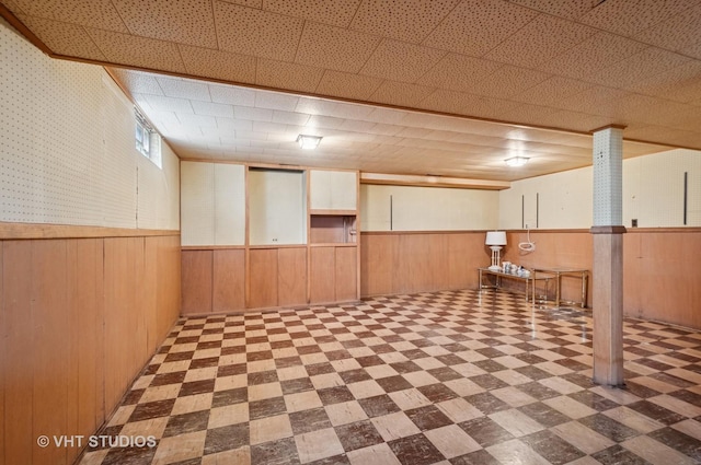 8223 N Washington St, Niles, IL 60714 - below grade area with tile patterned floors, a wainscoted wall, and wooden walls