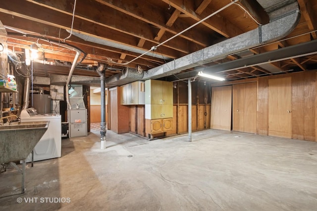 8223 N Washington St, Niles, IL 60714 - unfinished below grade area with a sink, heating unit, and washing machine and dryer