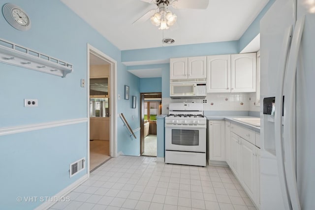 8223 N Washington St, Niles, IL 60714 - kitchen featuring white appliances, a ceiling fan, decorative backsplash, white cabinetry, and light countertops