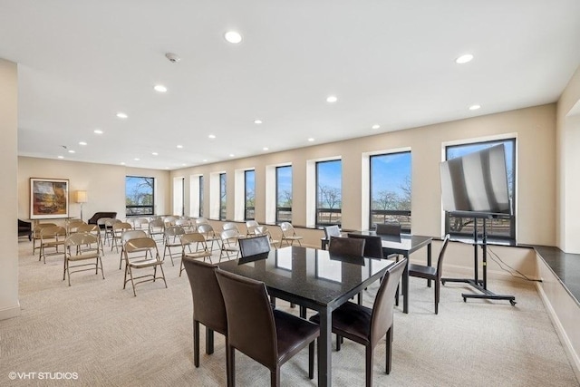 dining space featuring light colored carpet, baseboards, and recessed lighting