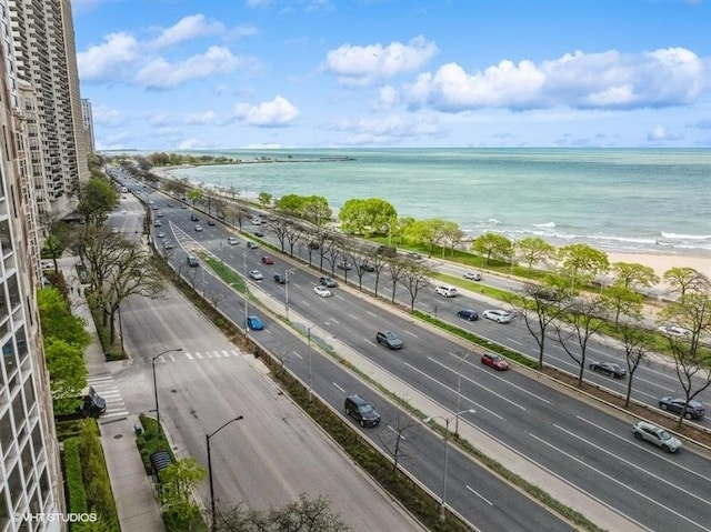birds eye view of property featuring a water view and a view of the beach