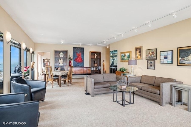 living room with light colored carpet and rail lighting
