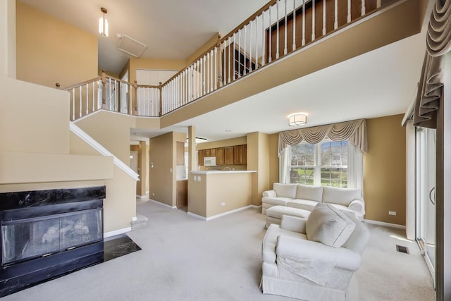 living room featuring baseboards, visible vents, and light colored carpet