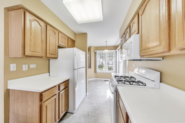 kitchen featuring white appliances, light countertops, light tile patterned floors, and light brown cabinets