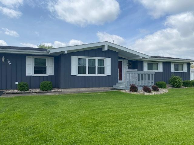 300 Marquette Ln, Spring Valley, IL 61362 - ranch-style home with board and batten siding, a front lawn, and a porch