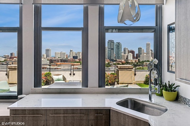 900 N Kingsbury St Unit 1150, Chicago, IL 60610 - kitchen with a sink, a view of skyline, dark brown cabinets, and healthy amount of natural light