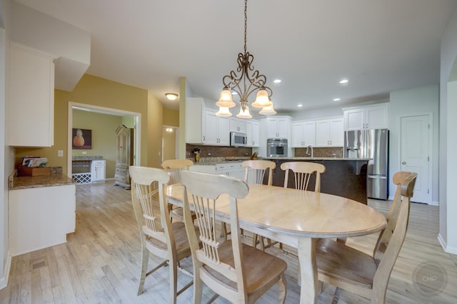 2411 Williamstown Ct, Naperville, IL 60564 - dining space featuring light wood-style floors, recessed lighting, a chandelier, and baseboards