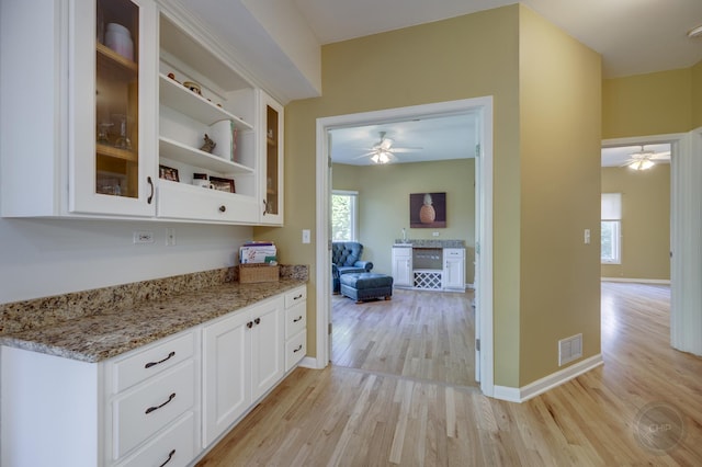 2411 Williamstown Ct, Naperville, IL 60564 - kitchen with ceiling fan, light wood-style floors, white cabinets, and light stone counters