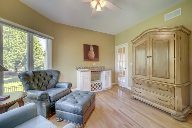 2411 Williamstown Ct, Naperville, IL 60564 - living area featuring ceiling fan, light wood-style flooring, baseboards, and bar