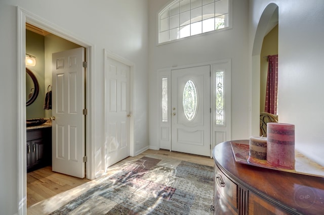 2411 Williamstown Ct, Naperville, IL 60564 - foyer with light wood finished floors, arched walkways, healthy amount of natural light, and a towering ceiling