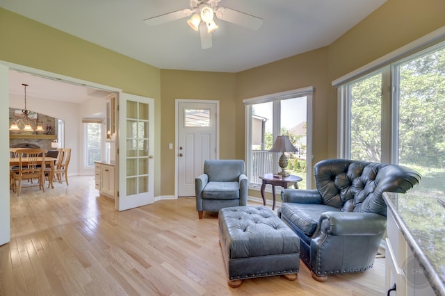 2411 Williamstown Ct, Naperville, IL 60564 - living area with light wood-style floors, a ceiling fan, baseboards, and a chandelier