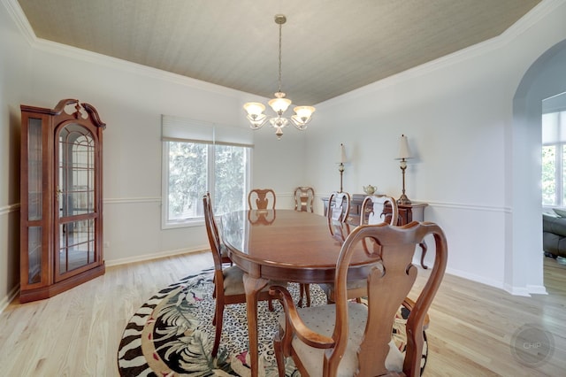 2411 Williamstown Ct, Naperville, IL 60564 - dining room with a chandelier, arched walkways, light wood-style flooring, crown molding, and baseboards
