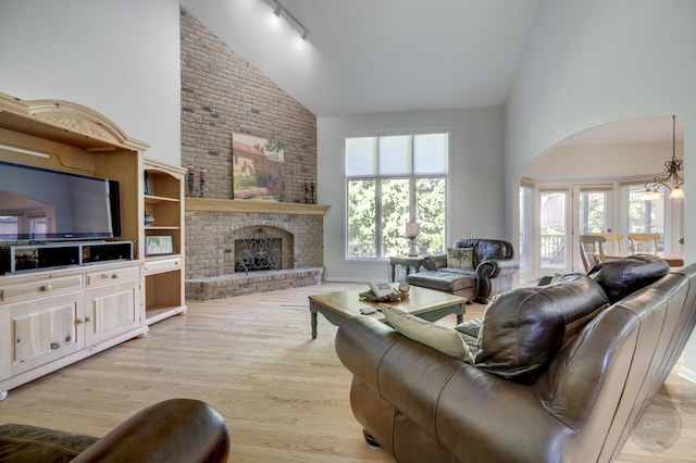 2411 Williamstown Ct, Naperville, IL 60564 - living area with high vaulted ceiling, light wood finished floors, rail lighting, and a brick fireplace