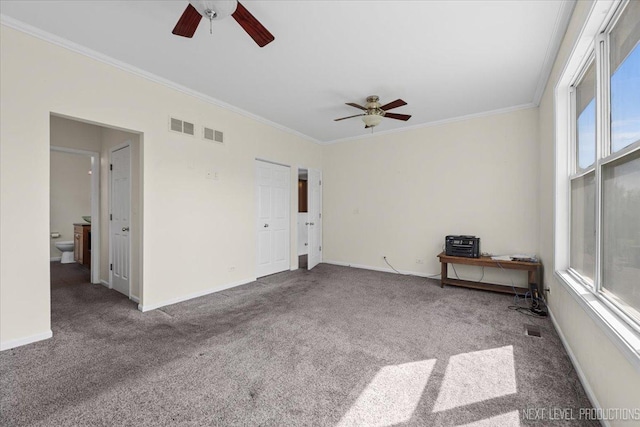 carpeted spare room with a ceiling fan, ornamental molding, plenty of natural light, and baseboards
