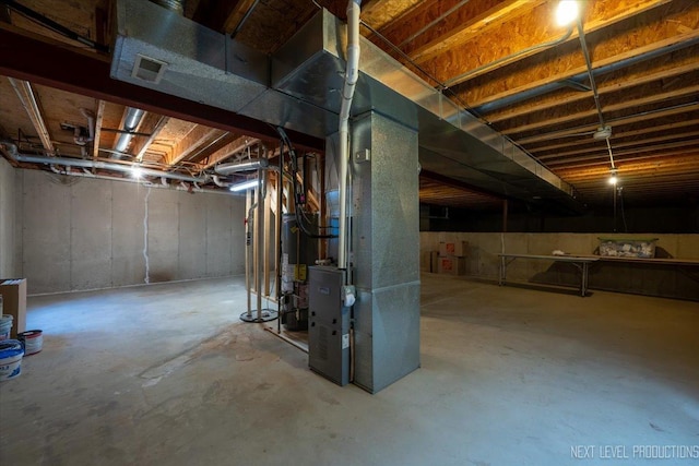 unfinished basement with heating unit and gas water heater