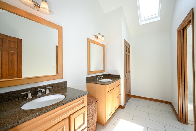 1408 Ambleside Cir, Naperville, IL 60540 - bathroom featuring vaulted ceiling, two vanities, tile patterned floors, a skylight, and baseboards