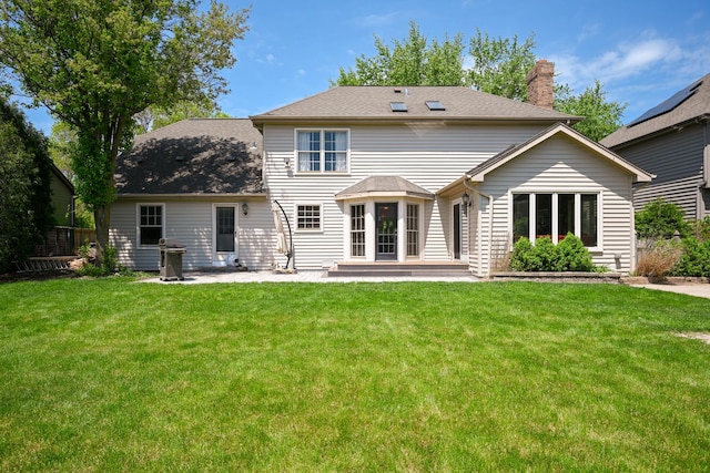 1408 Ambleside Cir, Naperville, IL 60540 - rear view of house featuring a patio area, a chimney, and a lawn
